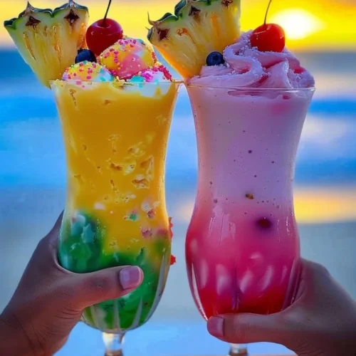 Colorful Rainbow Sherbet Piña Colada in a glass garnished with fruit