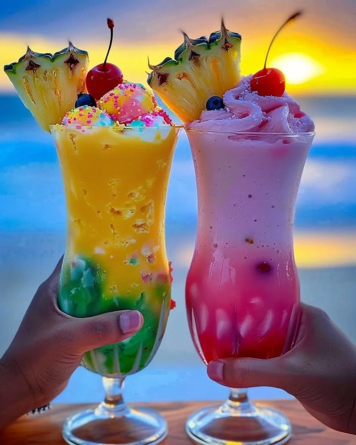 Colorful Rainbow Sherbet Piña Colada in a glass garnished with fruit