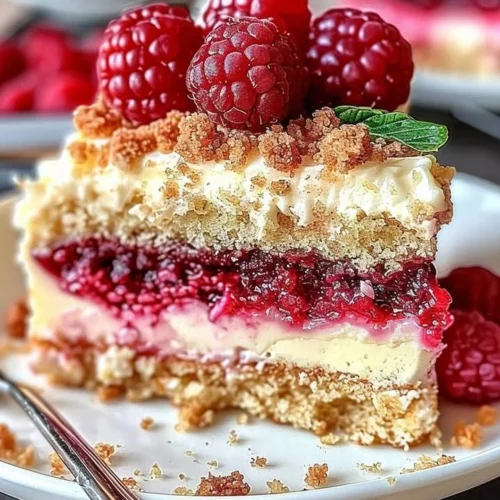 Raspberry Cream Cheese Coffee Cake slice on a plate with fork