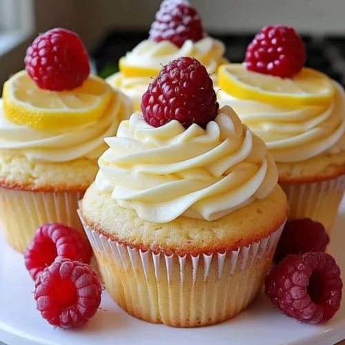 Delicious Raspberry Lemon Cupcakes topped with fresh raspberries and lemon frosting
