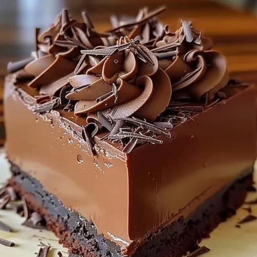 Rich chocolate mousse cake with a velvety texture and chocolate garnish