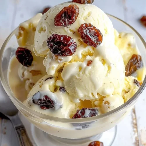 Delicious bowl of rum raisin ice cream topped with raisins