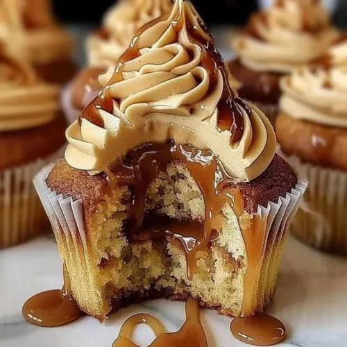 Delicious salted caramel cupcakes with creamy frosting and caramel drizzle