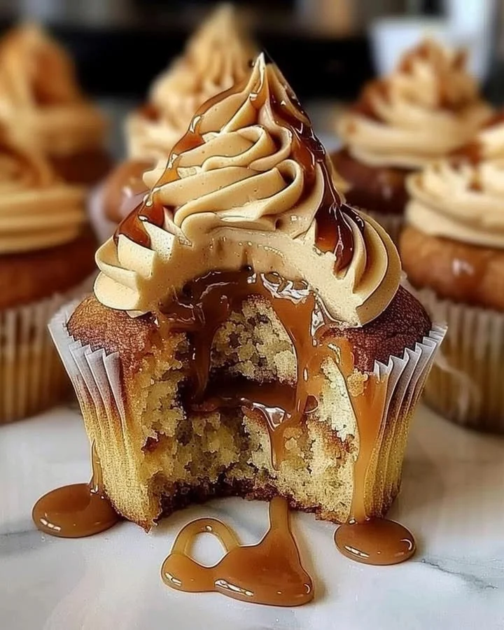 Delicious salted caramel cupcakes with creamy frosting and caramel drizzle