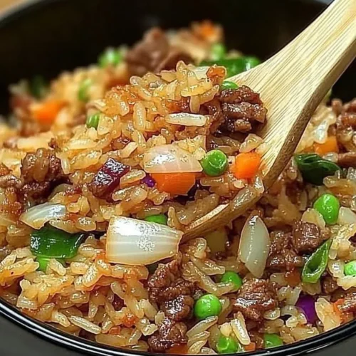 Savior Onion Beef Fried Rice garnished with green onions in a bowl