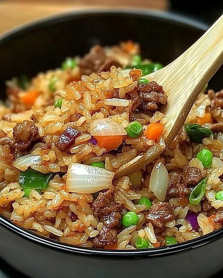 Savior Onion Beef Fried Rice garnished with green onions in a bowl