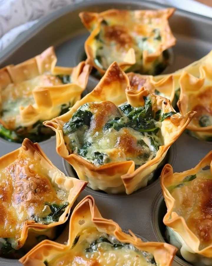 Baked spinach and artichoke wonton cups served on a platter