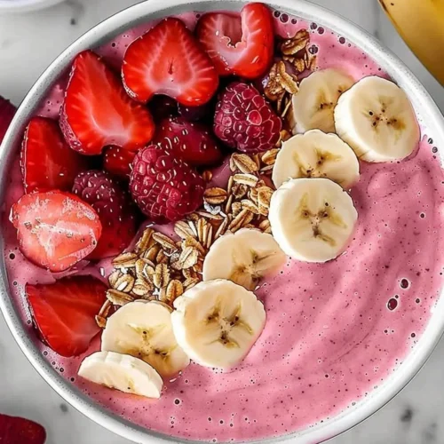 Delicious strawberry banana smoothie in a glass with fresh fruit