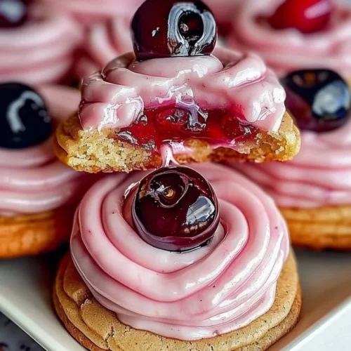 Strawberry Frosted Cherry Cookies topped with pink frosting and cherries