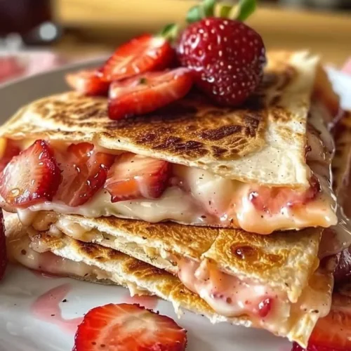 Sweet strawberry cheesecake quesadillas on a plate, ready to enjoy.