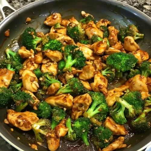 Szechuan-Style Chicken with Broccoli garnished with herbs and spices