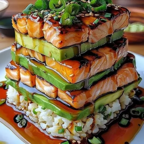 Delicious teriyaki salmon avocado rice stack served in a bowl.