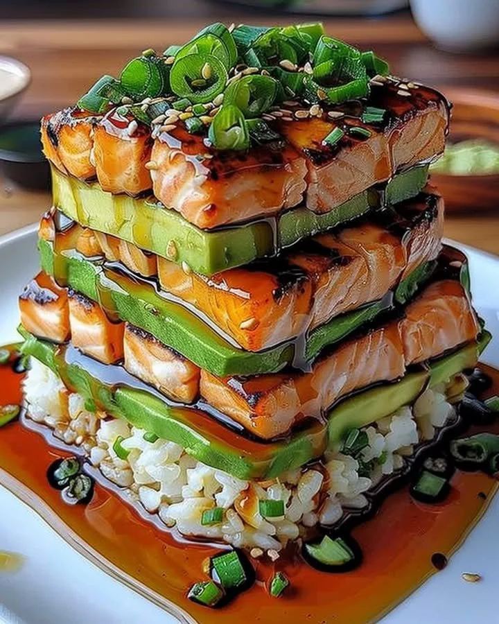 Delicious teriyaki salmon avocado rice stack served in a bowl.
