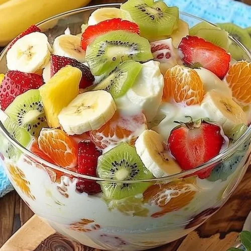 Tropical Cheesecake Fruit Salad with colorful fruits and creamy cheesecake topping
