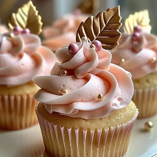 Vanilla cupcakes topped with blush pink buttercream frosting