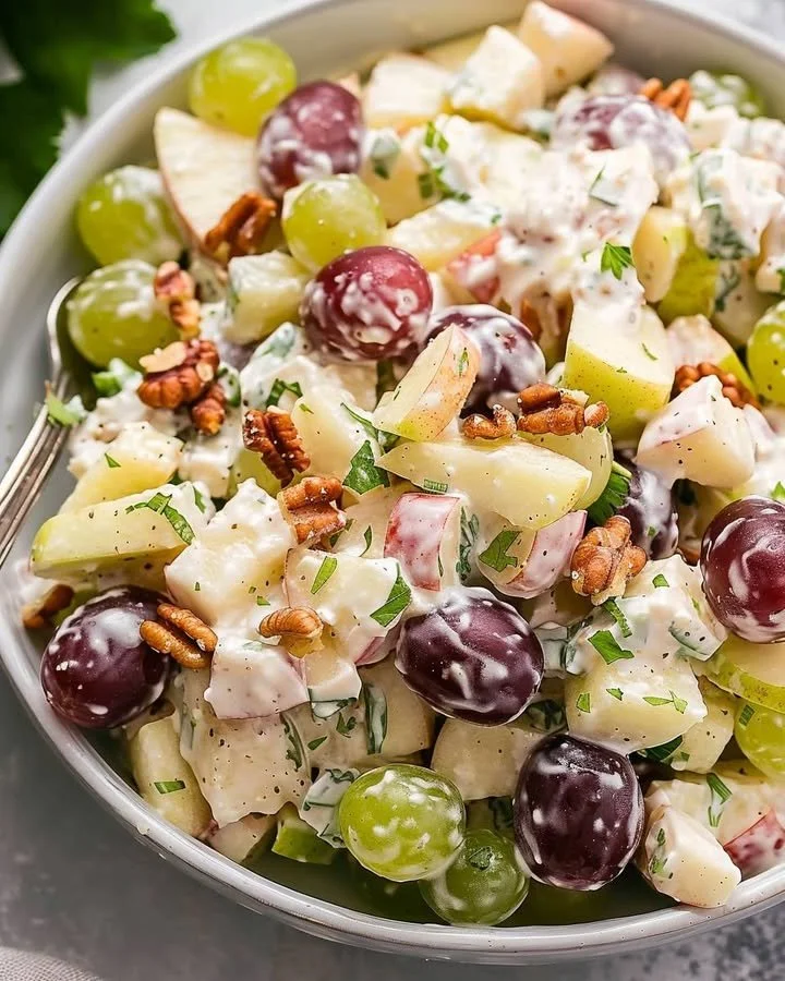 Fresh Waldorf Salad with apples, walnuts, and celery in a bowl