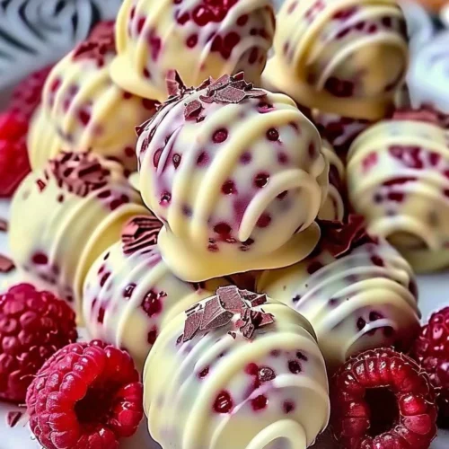 White chocolate raspberry cheesecake balls on a plate